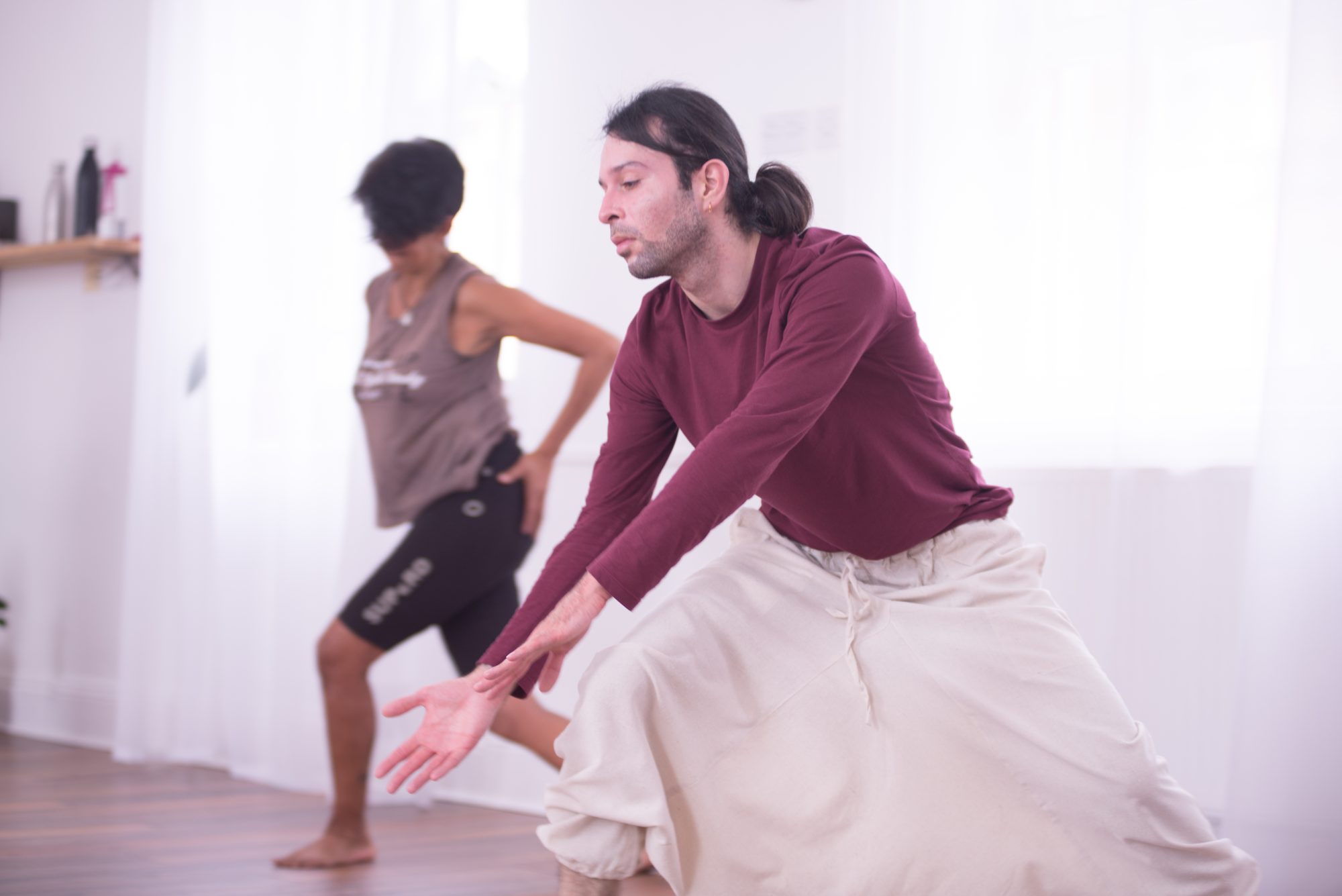A dancer in a deep, focused reach