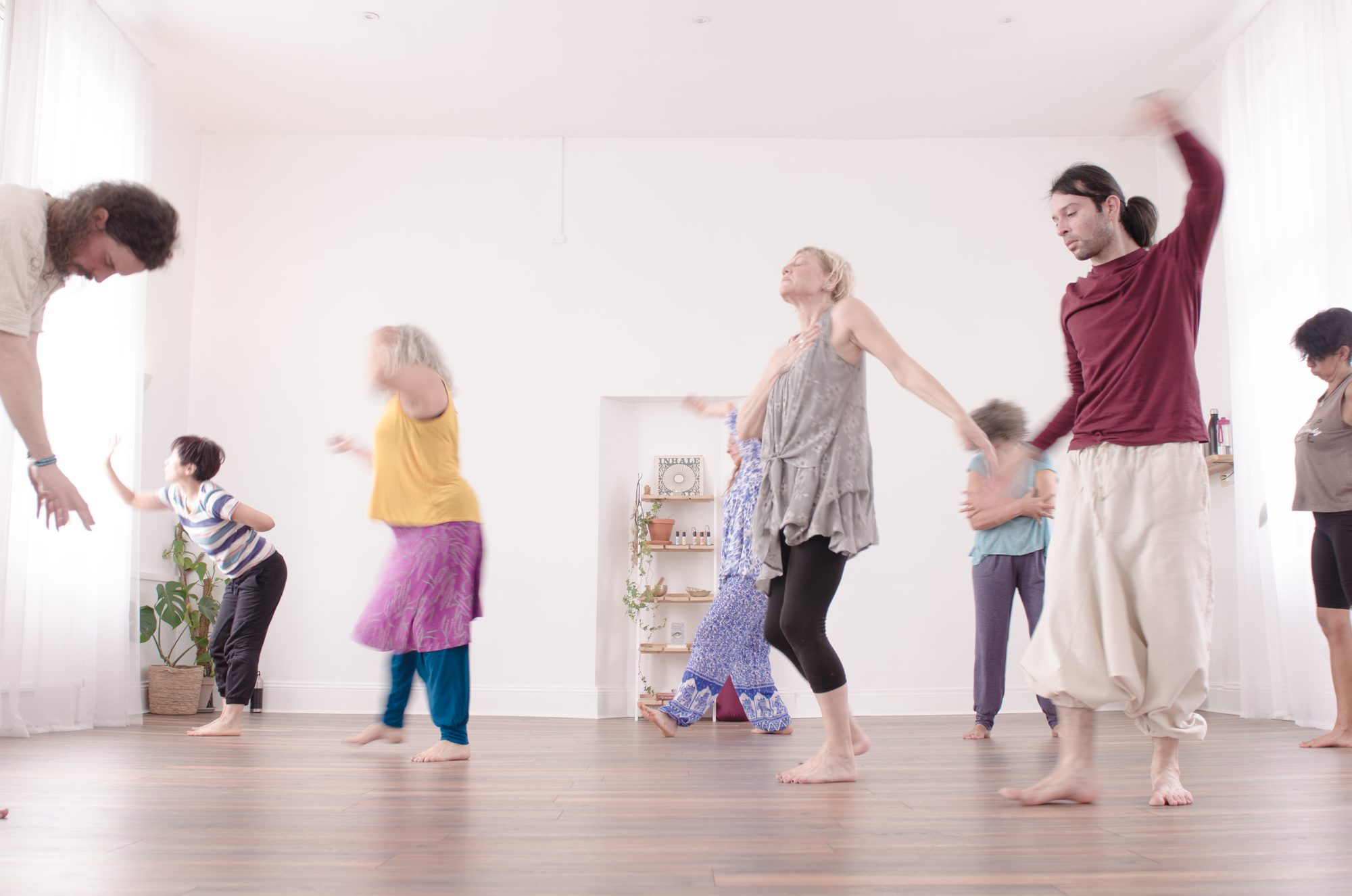 Dancers moving together, one with a hand on her heart