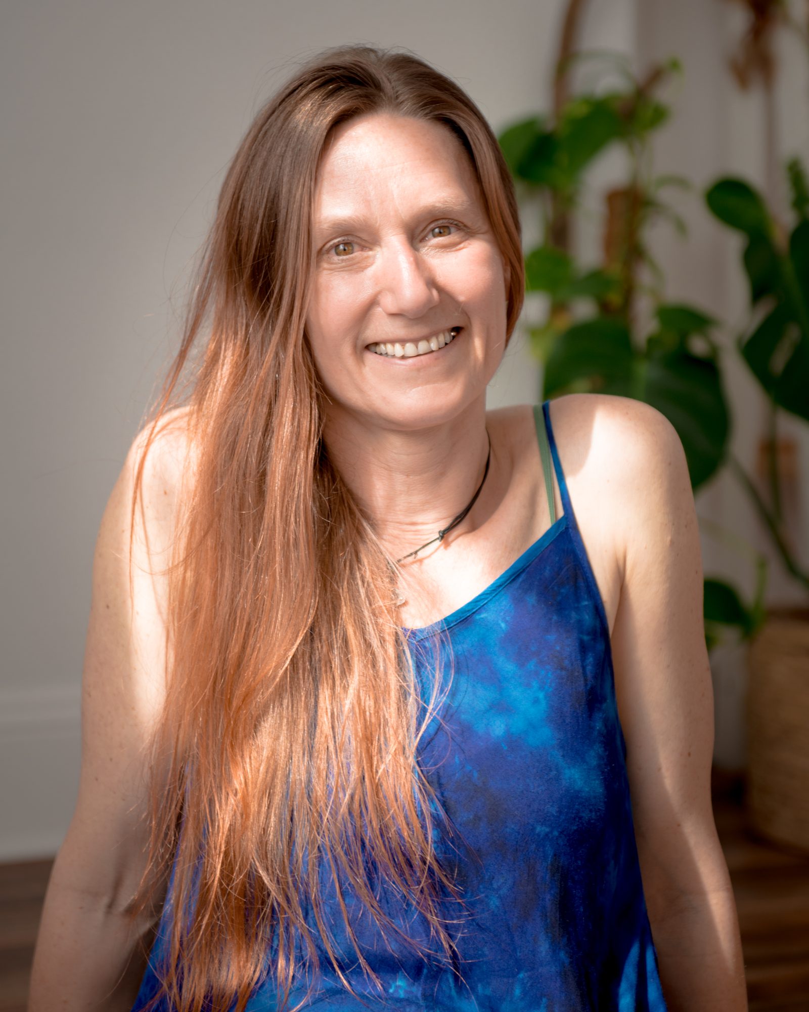 Rachel Godfrey-Kurtz smiling, long hair over a blue dress